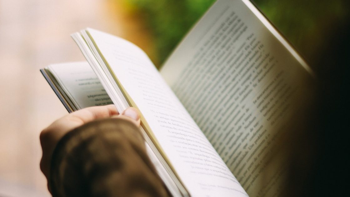 Розгорнута в руках книжка